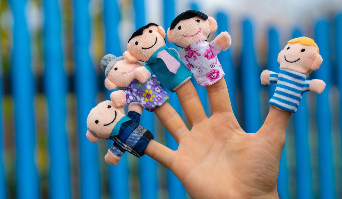 family finger puppet theater. child hand with finger puppets: son, daughter,mum, dad, granny, granddad. Kid playing fingers puppets. Family and generation concept.